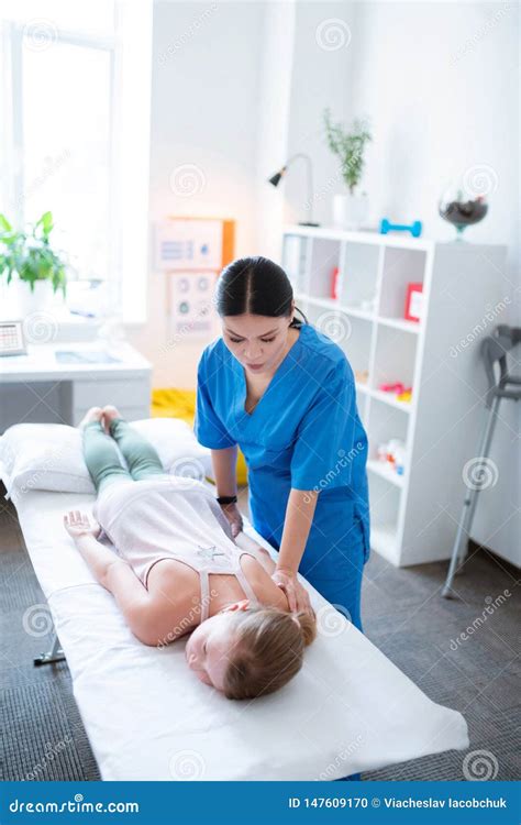 Young Skinny Girl Lying On Covered Daybed And Getting Ready For Massage