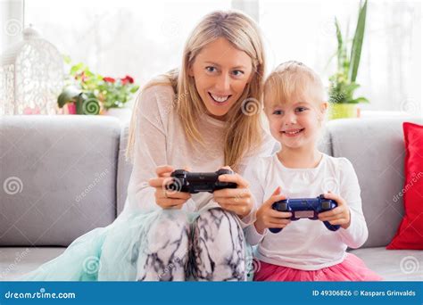 Mother And Daughter Playing Video Games In Bed Stock Photo Image Of