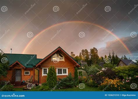 Small Country House On A Summer Evening Rainbow Over The House