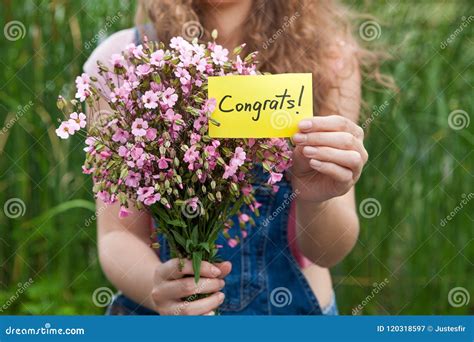 Congrats Beautiful Woman With Card And Bouquet Of Pink Flowers Stock