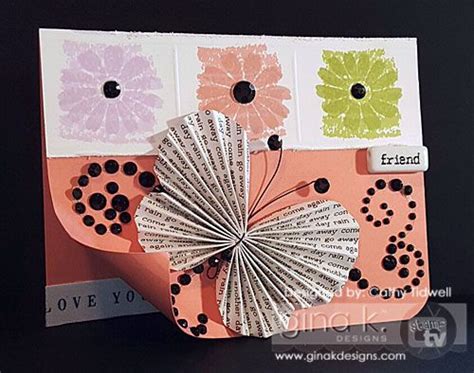 A Close Up Of A Card With Paper Flowers On It
