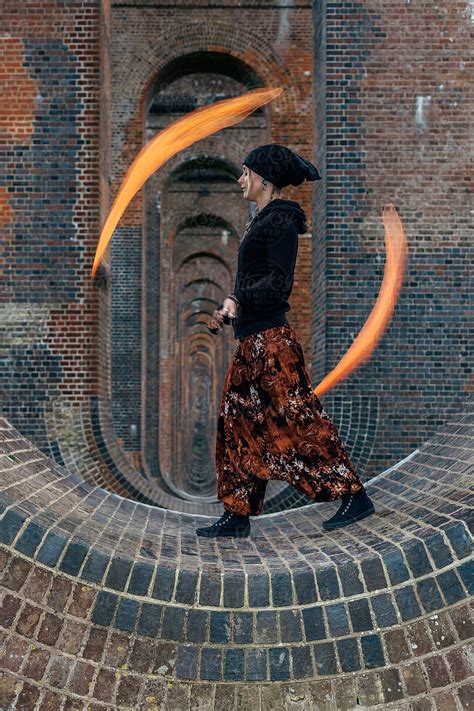 Flag Poi Performance Artist In The Arches Of A Viaduct By Stocksy