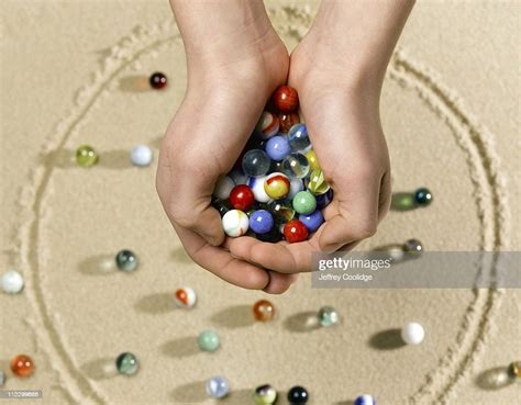 Hands Holding Marbles High Res Stock Photo Getty Images