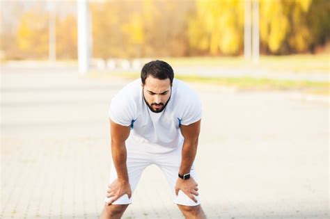 Tired Male Athlete Having Break After Jogging Free Photo