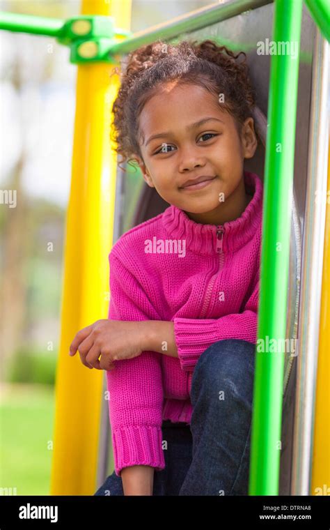 Outdoor Portrait Of A Cute African American Little Girl Playing At