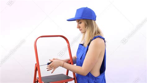 Naked Girl With Screwdriver In Blue Overalls Near Ladder At White
