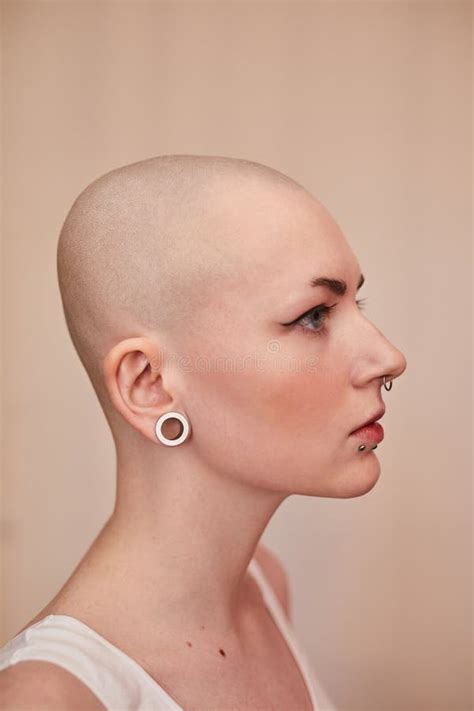 Short Haired Naked Woman With Piercing At Her Face Looking Straight While Posing Stock Photo