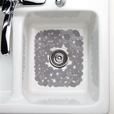 It's designed to allow the water to drain quickly without leaving an accumilation of water. Graphite Pebblz Sink Mat | The Container Store