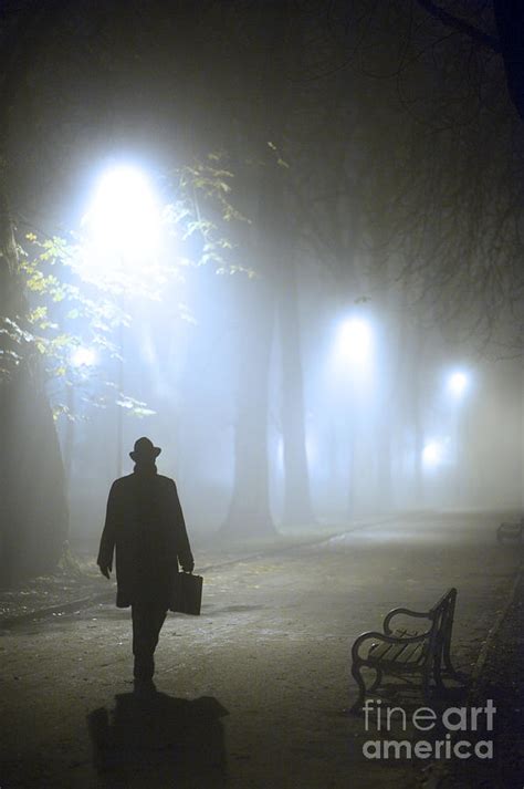 Man With Briefcase Walking On A Foggy Avenue At Night In Winter
