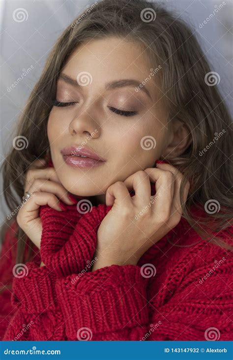 Beautiful Young Elegant Girl Enjoys The Tenderness And Warmth Of A Red