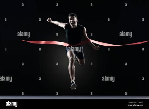 Runner Crossing Finish Line Stock Photo Alamy