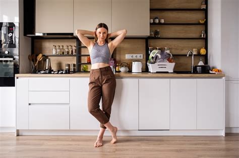 Free Photo Young Woman Posing On Modern Kitchen