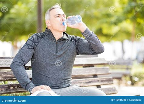 Mature Man Drinking Water To Refresh After A Workout Stock Photo