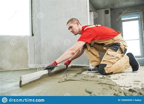 Floor Cement Work. Plasterer Smoothing Floor Surface with Screeder