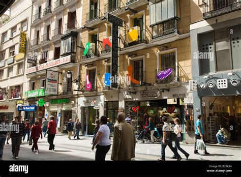 Spain Madrid People Walking Past Retail Stores In Pedestrian Shopping