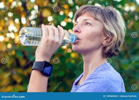 Portrait Of Happy Fitness Woman Drinking Water After Workout Out Stock