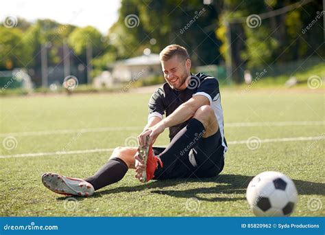 Injured Soccer Player With Ball On Football Field Stock Photo Image