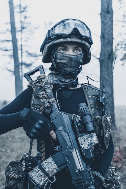 Premium Photo Girl In Camouflage With A Weapon