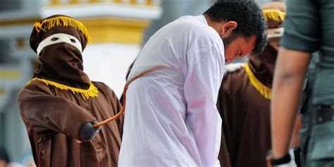 An Indonesian Crowd Cheers While Two Men Are Publicly Caned For Having