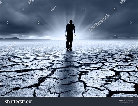 Troubled Young Man Walking Into Light Stock Photo