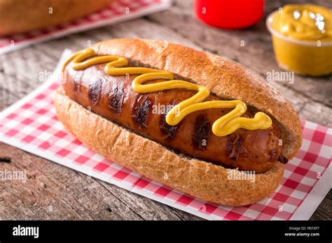 A Delicious Grilled Smoked Sausage On A Roll With Yellow Mustard Stock