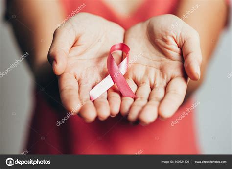 healthcare and medicine concept womans hands holding pink breast cancer awareness ribbon