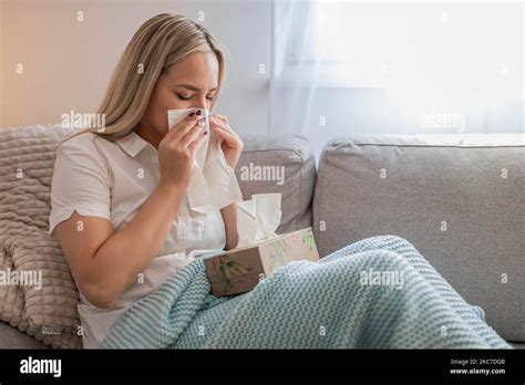 Sick Woman Blowing Nose Sitting Under The Blanket Sick Woman With