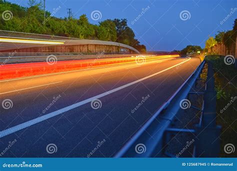 Highway At Twilight With Light Trails High Traffic Road With