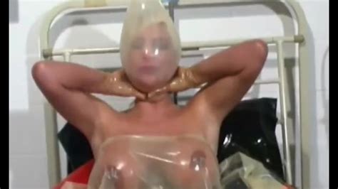 Hot Milf With Latex Condom Hood On Her Head And Rubber Sheet Has Fun With Breathing Games