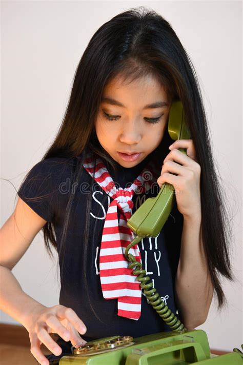 The Beautiful Little Girl In Vintage Style Talking On Phone Stock Photo