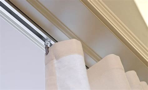 Ceiling mount curtain tracks afford floor to ceiling coverage with curtain panels. The Tracks In Our Home | Photo Arranging | Ceiling curtain ...