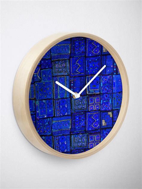 A Clock That Is On The Wall With Blue Tiles In Its Face And Hands
