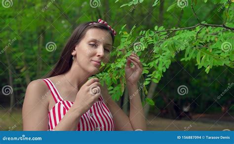 Beautiful Girl Stroking Herself With Leaves From A Tree Stock Footage