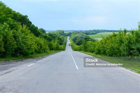 Asphalt Road Goes Into The Distance Green Trees Are On Both Sides Stock