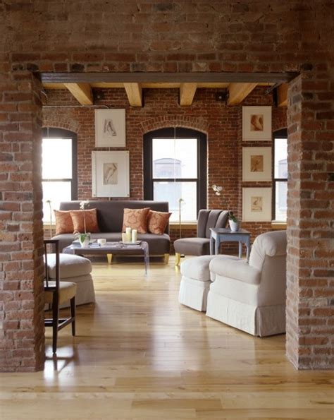 A Chic Living Room With Red Brick Walls Highlighted With White Grout