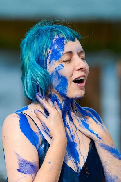 Premium Photo Artistic Blue Haired Woman Performance Artist In Dark Blue Dress Smeared With