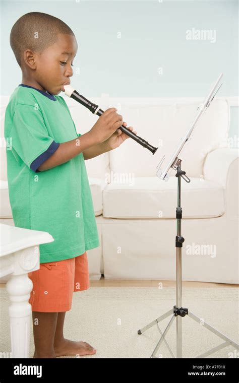 African Boy Playing A Recorder With Sheet Music Stock Photo Alamy