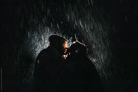 Couple Kissing Under The Rain By Stocksy Contributor Yurii Shevchenko Stocksy
