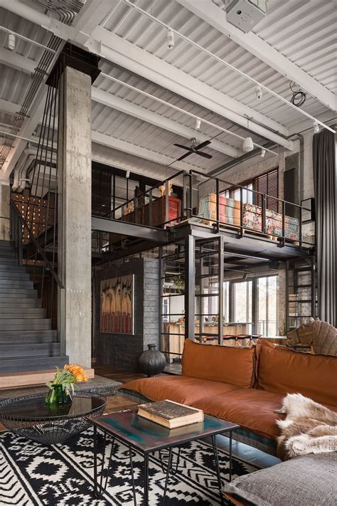 A Living Room Filled With Furniture Next To A Stair Case In A Loft