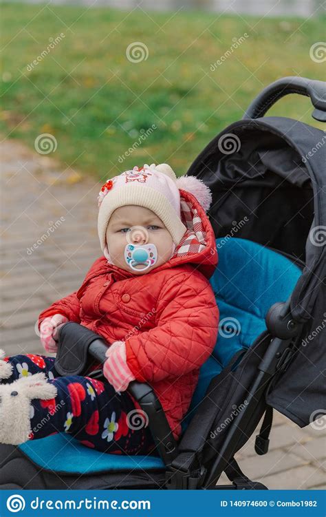 The Little Baby Is Sitting In The Pram Stock Photo Image Of Mother