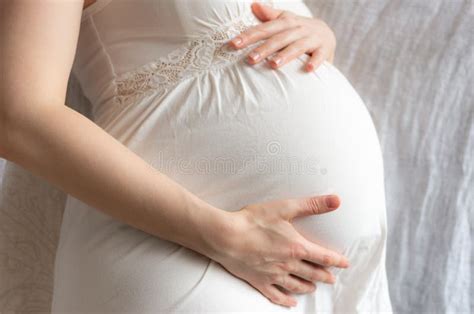 Pregnant Woman Expectant Mother On White Background Close Up Of Pregnant Belly Activity