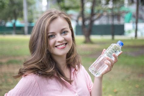 Smiling Young Caucasian Woman Girl Holding Drinking Water From A