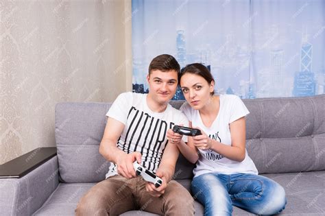 Premium Photo Cheerful Young Male And Female Gamers Playing Video