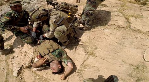 Wounded Peshmerga soldier receiving tactical casualty combat care from ...