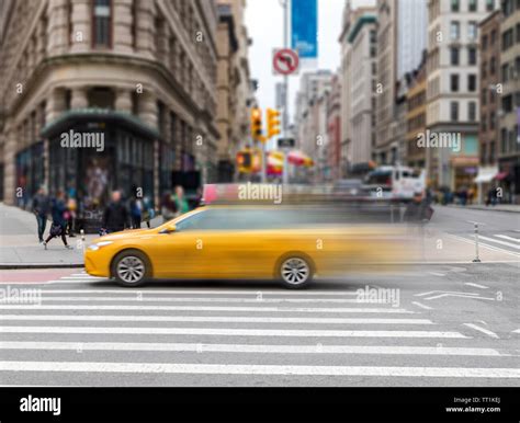 Motion Blur Of Yellow Taxi Cab Speeding Through An Intersection On 23rd