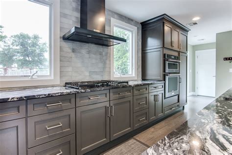 Black Stainless Steel Kitchenaid Rangehood In Between Windows In A Gray