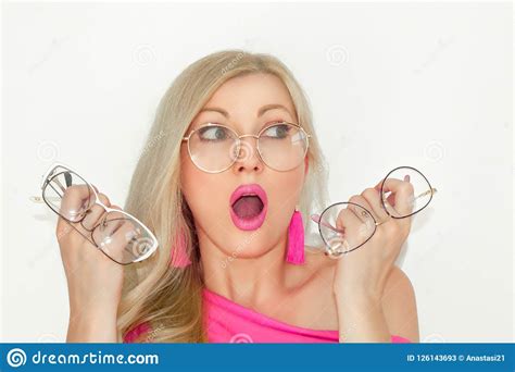 Confused Beautiful Young Blonde With Glasses Holds Three Pairs Of