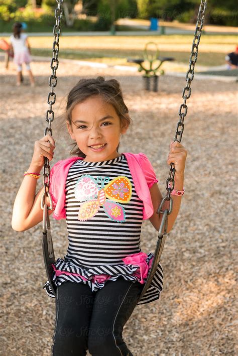 Girl On Swing At Playground By Stocksy Contributor Ronnie Comeau Stocksy