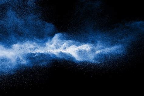 Splash Of Blue Color Powder Dust On Black Background Stock Photo