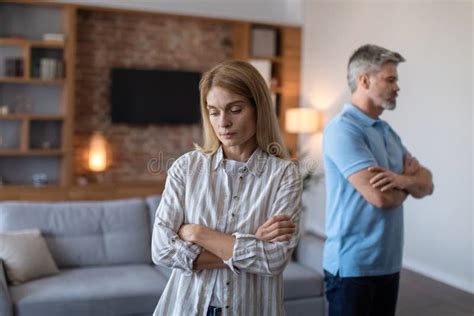 Unhappy Sad Middle Aged European Husband Ignores Offended Wife After Scandal And Think About